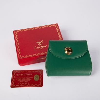 CARTIER, Must
Green leather wallet, in its...