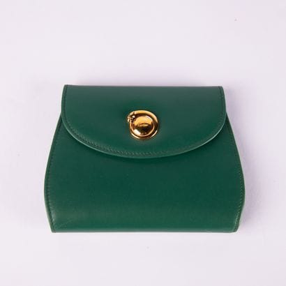CARTIER, Must
Green leather wallet, in its...