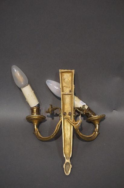 Pair of bronze sconces decorated with quivers....