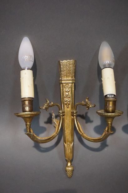 Pair of bronze sconces decorated with quivers....
