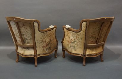 Pair of low bergères in molded natural wood,...