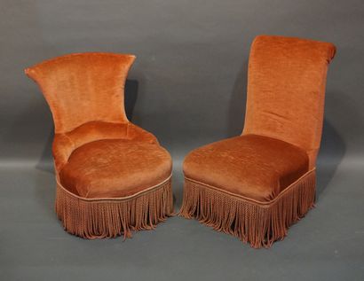 Two pink velvet armchairs with blackened...