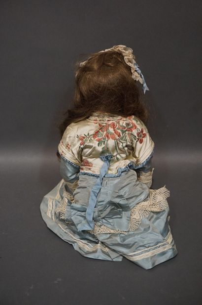 Doll with porcelain head and fixed eyes (one...