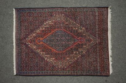 Small rug with geometric cartouche on burgundy...