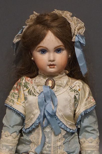 Doll with porcelain head and fixed eyes (one...