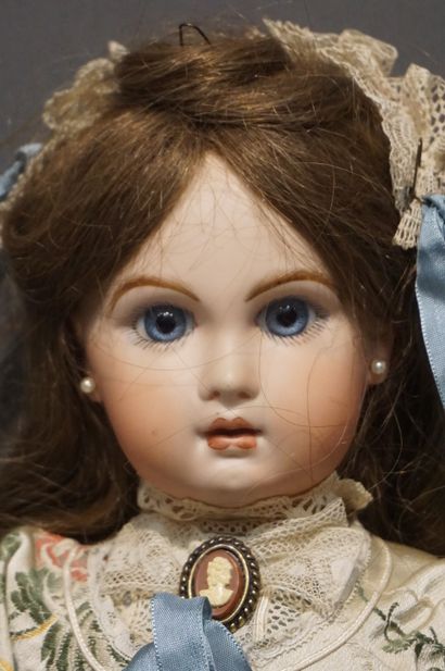 Doll with porcelain head and fixed eyes (one...