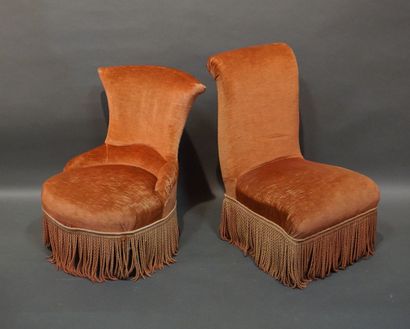 Two pink velvet armchairs with blackened...