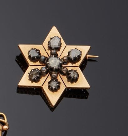 Broche en or 18k (750e), stylisant une étoile,...
