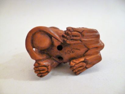 Boxwood netsuke of a standing shishi with...
