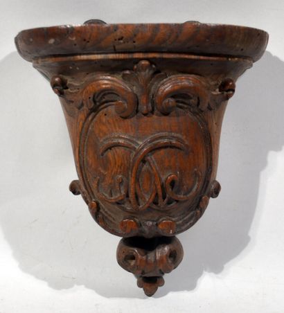 A small carved wood shelf with scrolls and...