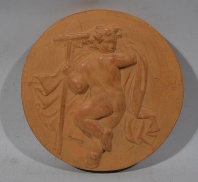 Terracotta MEDAL decorated with a putto with...