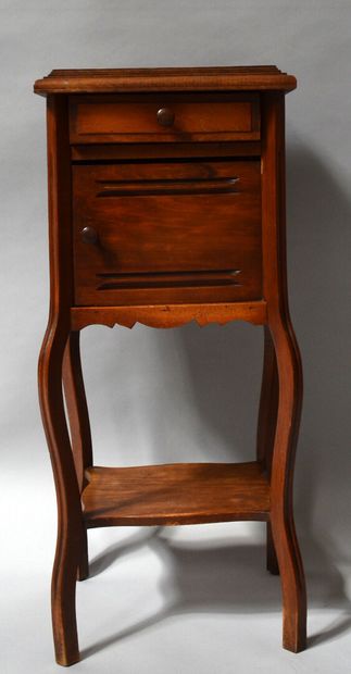 A moulded wooden CHEVET opening to a door...