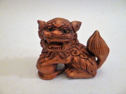 Boxwood netsuke of a standing shishi with...