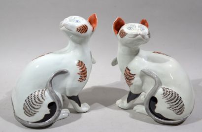 A pair of polychrome porcelain cats.

Work...