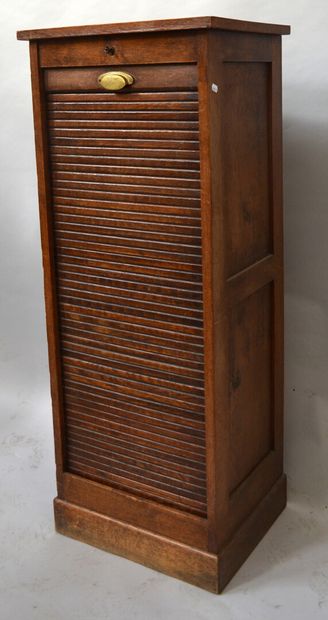 Oak filing cabinet opening with a curtain...
