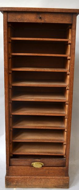 Oak filing cabinet opening with a curtain...