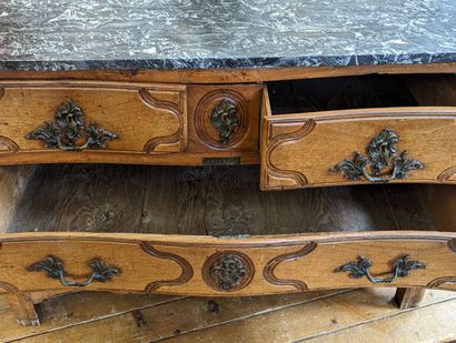 Commode galbée en chêne mouluré et sculpté....