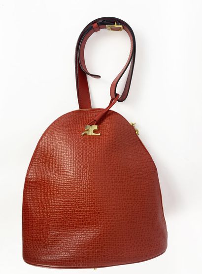COURREGES
Red leather handbag, oval-shaped,...