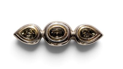 YVES SAINT LAURENT
Metal brooch adorned with...