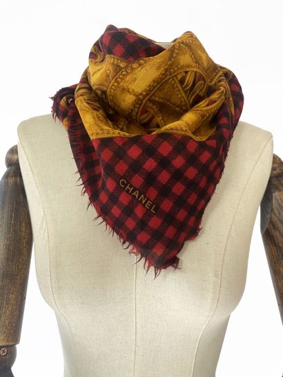 CHANEL
A square muslin scarf with a black-and-red...