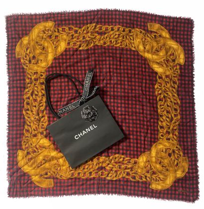 CHANEL
A square muslin scarf with a black-and-red...
