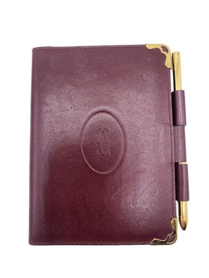CARTIER
Burgundy leather planner case, with...