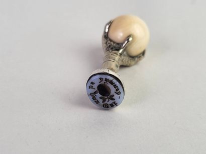 Silver seal showing an eagle's claw holding...