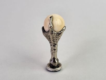 Silver seal showing an eagle's claw holding...