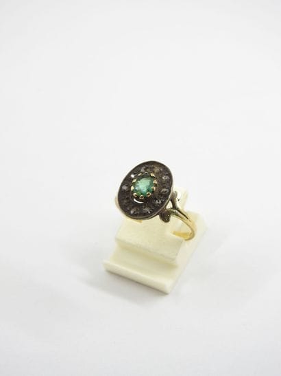 Yellow gold ring decorated with a green stone....