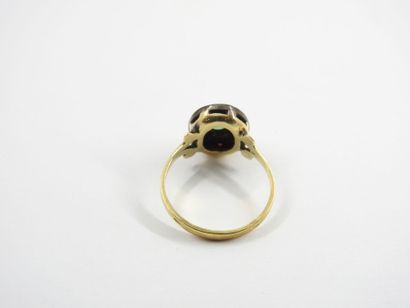 Yellow gold ring decorated with a green stone....