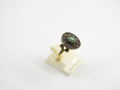 Yellow gold ring decorated with a green stone....