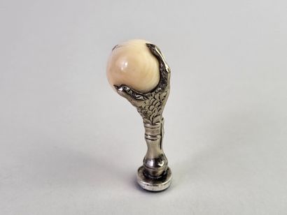 Silver seal showing an eagle's claw holding...