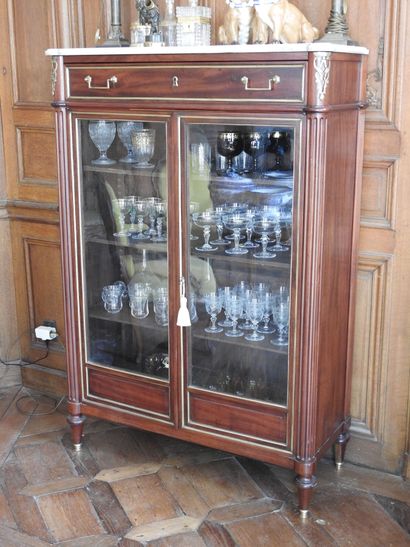 Mahogany and brass fillets showcase in the...