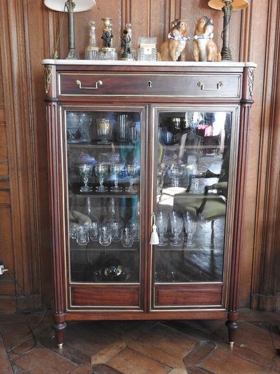 Mahogany and brass fillets showcase in the...
