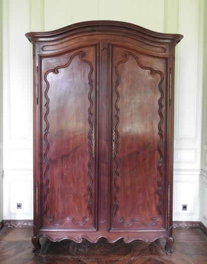 Mahogany cabinet molded and carved with cornice...
