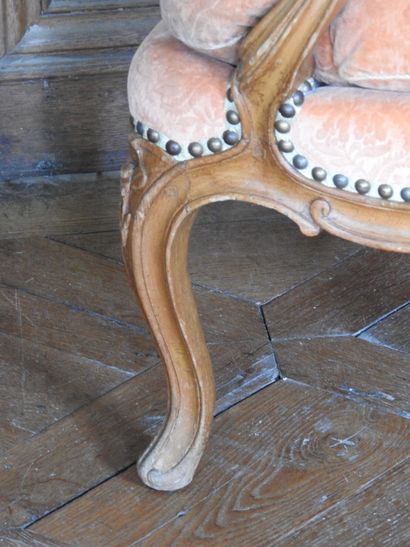 A cabriolet armchair in natural wood molded...