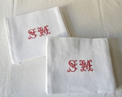 Nine large towels with S.M. in red.
