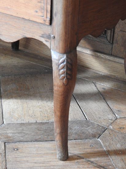 An oak table with an inlaid top forming a...