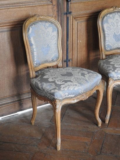 Pair of chairs in natural wood, molded and...