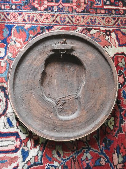 Terracotta medallion encircled with gilt...