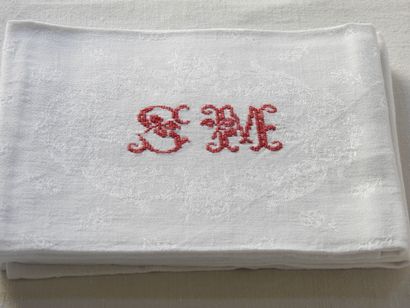 Nine large towels with S.M. in red.