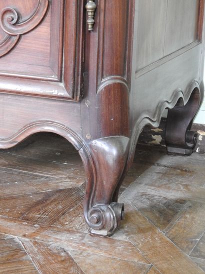 Mahogany cabinet molded and carved with cornice...
