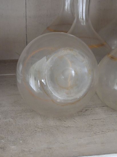 Suite of seven glass decanters with gilded...