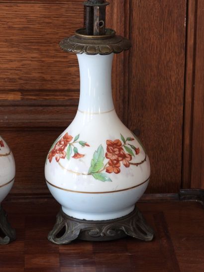 Pair of porcelain oil lamps with polychrome...