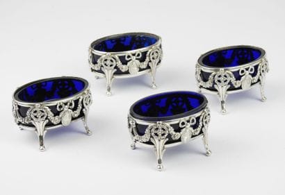 Suite of four silver salerons of oval form...