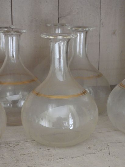 Suite of seven glass decanters with gilded...