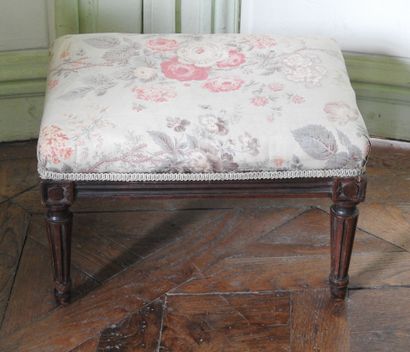 Rectangular footrest in natural wood resting...