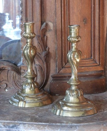 Pair of bronze torches with rocaille decoration....