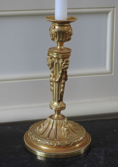 Pair of ormolu torches decorated with garlands...