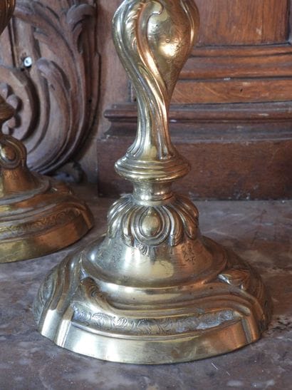 Pair of bronze torches with rocaille decoration....